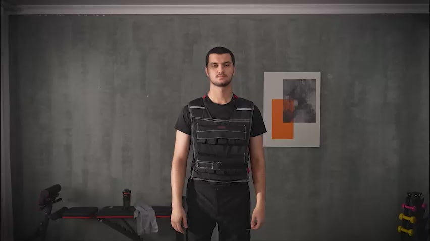 Load video: Person using an adjustable weighted vest for strength training and cardio exercises, demonstrating its fit and versatility for full-body workouts.